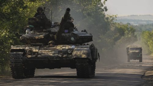 A Ukrainian tank drives in Donetsk region, eastern Ukraine, Thursday, June 9, 2022. 