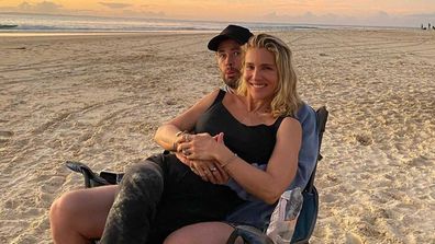 Liam Hemsworth and Elsa Pataky cuddle on the beach.