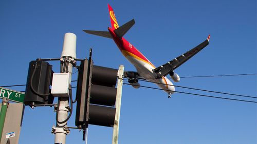 A passenger jet makes its final approach for landing into Sydney Airport.