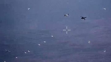 The Russian fighters dropped parachute flares at a US drone (seen bottom left).
