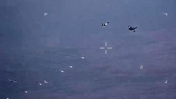The Russian fighters dropped parachute flares at a US drone (seen bottom left).