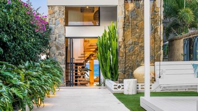 The four-bedroom home crafted from timber and stone has almost 13-metre beach frontage Domain luxury beach house