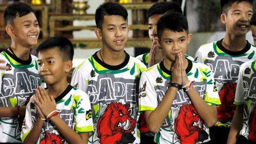 Some of the 12 members of the Wild Boars soccer team greet the media. Picture: EPA/AAP