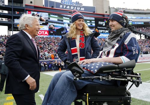 In this 2014 photo, New England Patriots owner Robert Kraft smiles with Pete Frates and his wife, Julie, during a birthday ceremony for Pete during a break in an NFL football game between the Patriots and the Buffalo Bills.