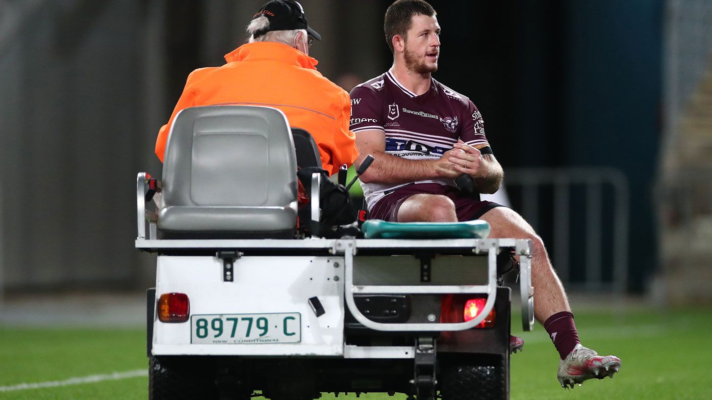 Cade Cust is taken from the field injured in Manly&#x27;s win over the Bulldogs. (Getty)