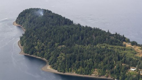 Smoke rises from the site on Ketron Island.