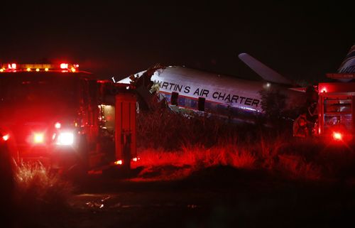 A charter plane lays in a field in Pretoria, South Africa, Tuesday July 10, 2018. The plane crashed killing one person and injuring 20 others with injuries ranging from minor to critical, according to Russel Meiring, a spokesman for paramedic company ER24. (AP Photo/Phil Magakoe) 