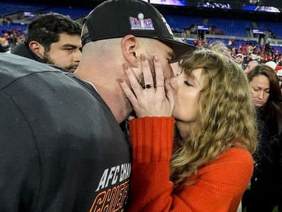 Taylor Swift kisses Kansas City Chiefs tight end Travis Kelce after an AFC Championship NFL football game against the Baltimore Ravens.