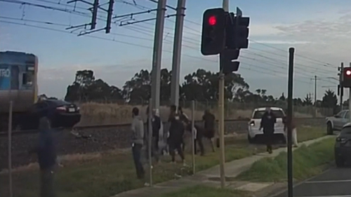 Vision of a car on the Melbourne train trucks being hit by a train