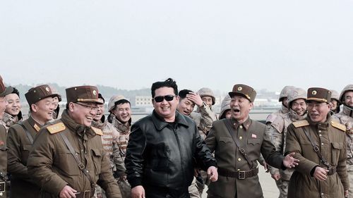 North Korean leader Kim Jong Un joins North Korean military personnel during the test launch operation of what state media reports a new type inter-continental ballistic missile. 