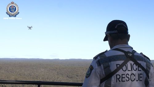 A NSW Police drone pilot sends a drone into the air.