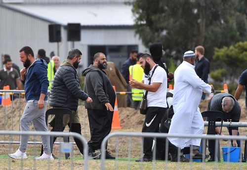 Mourners wash themselves after the funerals. (AAP Image/Mick Tsikas) 