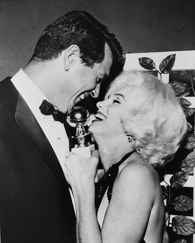 Marilyn Monroe receives her Golden Globe award from Rock Hudson at the Hollywood Foreign Press Association's 19th Annual Dinner, Beverly Hilton