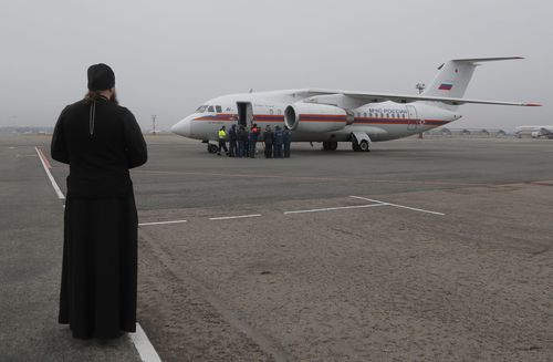 An Orthodox priest looks on as a Russian Ministry for Emergency Situations plane carrying bodies of victims of the Russian plane crash in Egypt, at Pulkovo airport outside St. Petersburg, Russia, 06 November 2015. All 224 people onboard a Russian MetroJet Airbus A321 plane en route from the Red Sea resort of Sharm el-Sheikh to Russian St. Petersburg were killed in the crash on 31 October 2015. British security experts believe a bomb placed in the plane's hold caused the crash of the Russian passenger jet in Egypt's Sinai Peninsula, the BBC and other media said 06 November. EPA/DMITRY LOVETSKY / POOL