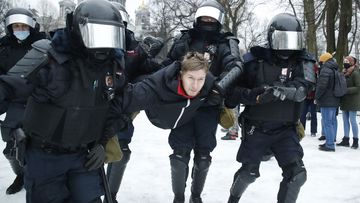 Police detain a man during a protest against the jailing of opposition leader Alexei Navalny in People gather in St.Petersburg, Russia, Saturday, Jan. 23, 2021.