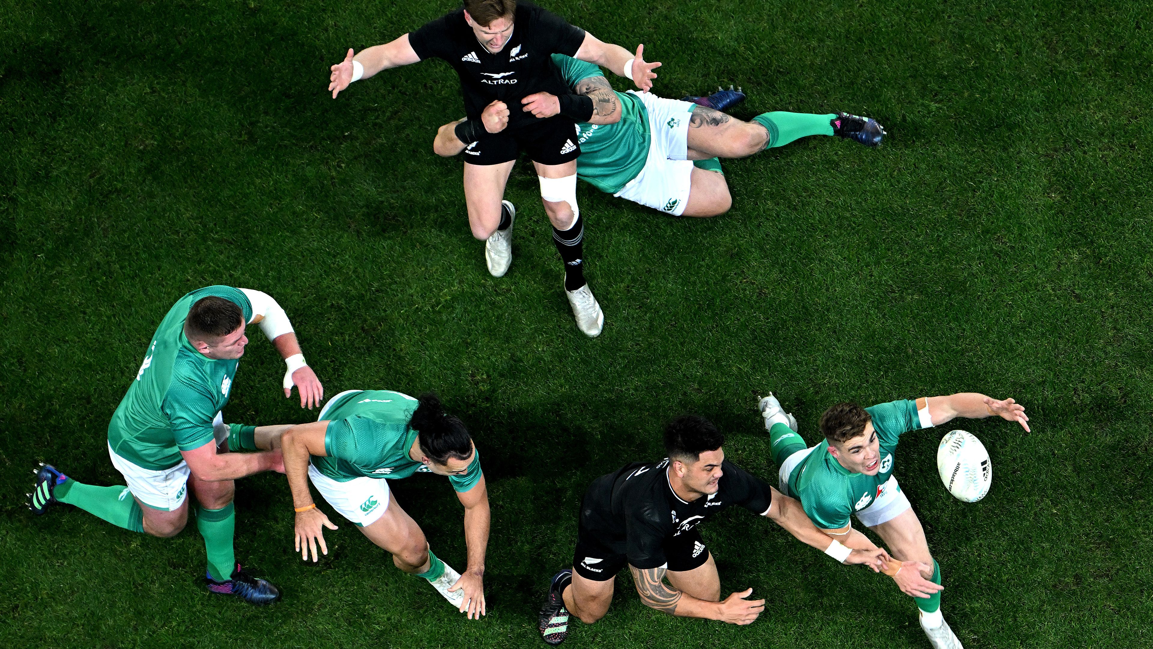 Hugo Keenan of Ireland looks to secure the ball away from Quinn Tupaea of the All Blacks during a Test in 2022.