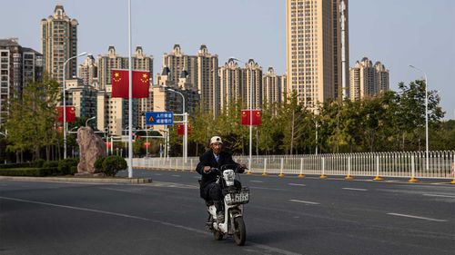 A resident cycles through the Evergrande city in Wuhan.