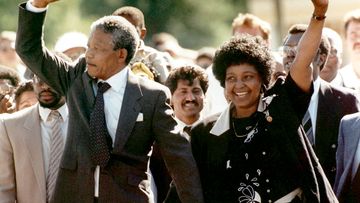 Nelson Mandela and wife Winnie, walk hand-in hand-with their raised clenched fists upon Mandela's release from Victor Verster prison in 1990. (AAP)