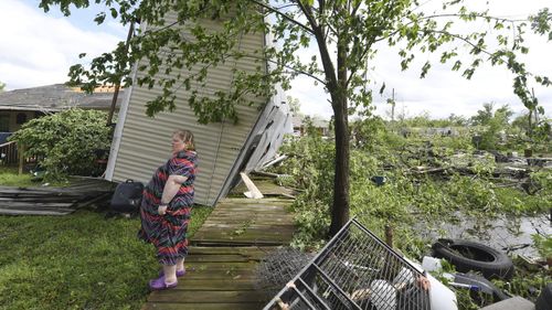 Angel Funk stands in the backyard of her Franklin, Texas, home following severe weather. Funk's home was struck by her neighbour's mobile home, but she and her husband, who were home at the time, escaped unharmed.