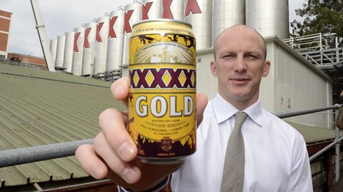 Queensland Rugby League legend Darren Lockyer poses with a can of a special edition XXXX beer at their Milton brewery in Brisbane, 2013