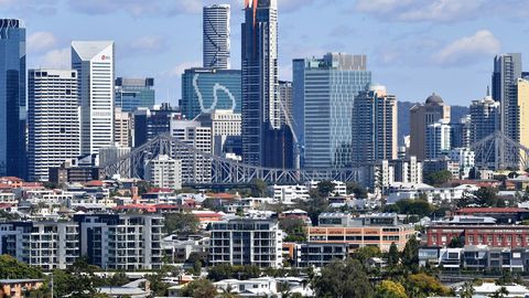 Houses and apartment buildings are seen against the Brisbane CBD skyline in Brisbane.