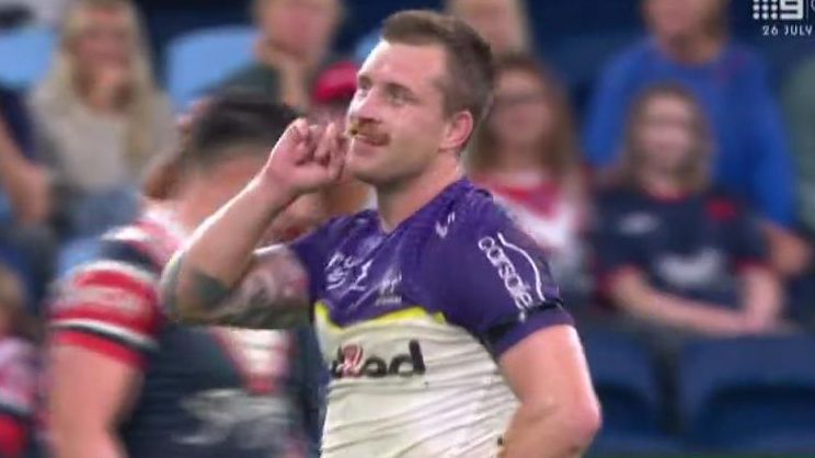 Cameron Munster puts a finger to his ear as boos from the Sydney crowd ring out.