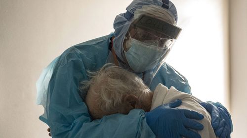 Dr. Joseph Varon hugs and comforts a patient in the Covid-19 ICU during Thanksgiving at the United Memorial Medical Center in Houston.