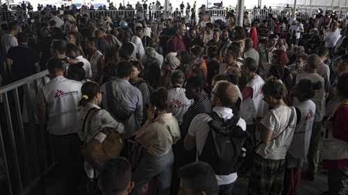 Palestinians and foreign aid workers wait to cross into Egypt at Rafah, Gaza Strip, on Wednesday, Nov. 1, 2023.