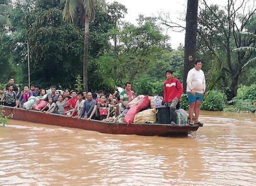 Lao villagers evacuate on a boat after the Xe Pian Xe Nam Noy dam collapsed. Picture: AP