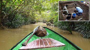 A boat travels up the Marang River in east Borneo, towards the Liang Tebo cave.