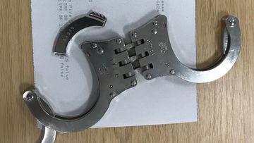 A British police officer needed to be rescued by firefighters after getting his hands stuck in a pair of handcuffs.