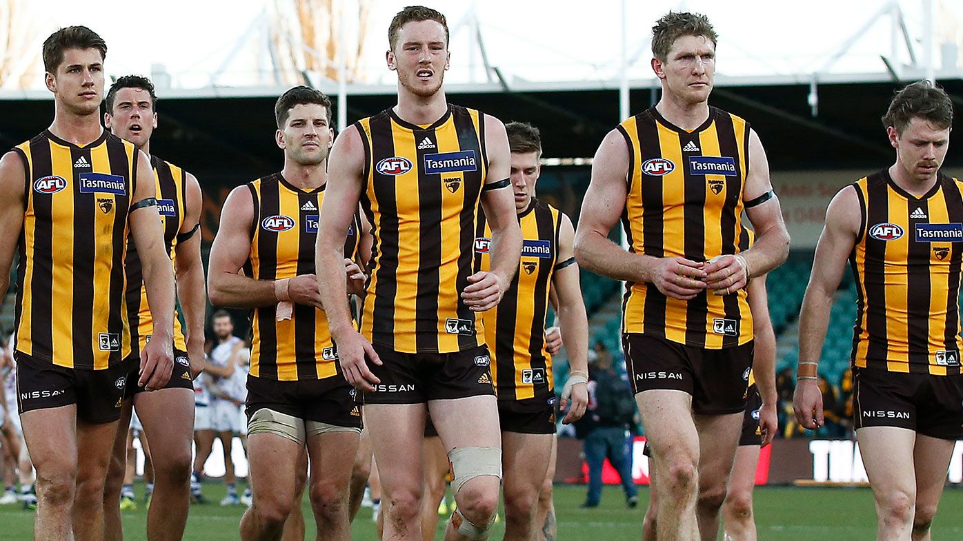 Hawthorn players leave the field after being thrashed by Fremantle.