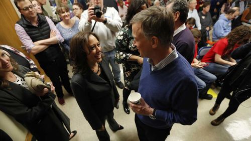 Kamala Harris and John Hickenlooper, seen herer chatting at a Iowa function, are both running for president.