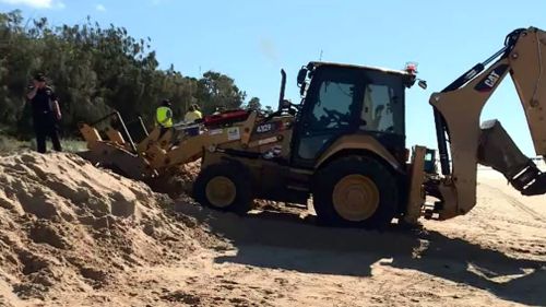 An excavator has been called in to help free the man. Picture: 9NEWS