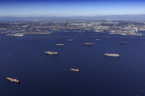 A log jam of container ships moored off the Los Angeles and Long Beach ports in California, US.