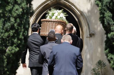 The coffin is carried into the church by pallbearers during the funeral of Dame Deborah James at St Mary's Church on July 20, 2022 in Barnes, England
