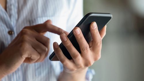 A woman moves her smartphone