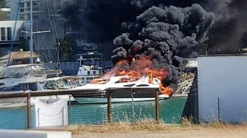 Firefighters are working to protect about half a dozen boats at Townsville's Marina after a parked boat caught fire this afternoon. 