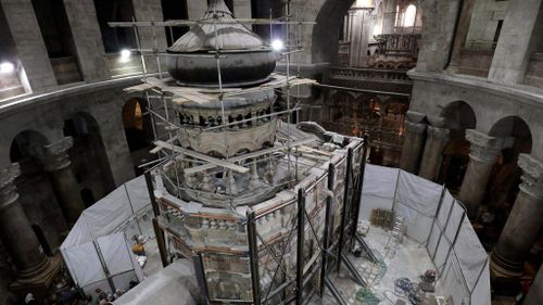 Greek preservation experts work to strengthen the Edicule surrounding the Tomb of Jesus on October 28, 2016. (AFP)