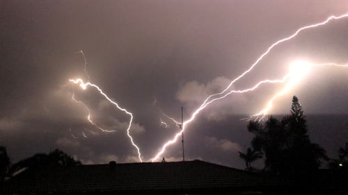Lightning crackles over Queensland homes. (Samuel Swift)