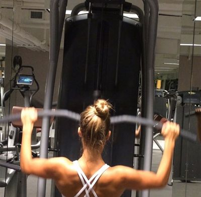 She loves to hit the weights in the gym.