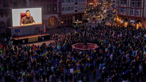 Ukrainian President Volodymyr Zelenskyy delivers a video message to the people joining a rally on the Remember square in Frankfurt, Germany.