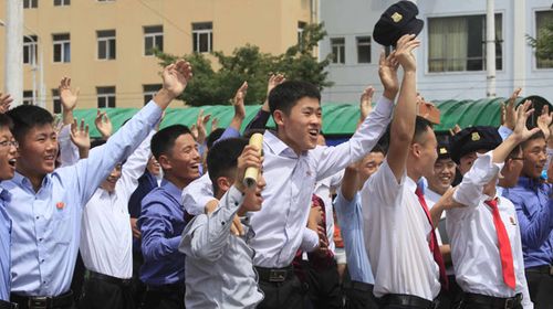 North Koreans cheer the latest test on the streets of Pyongyang. (AAP)