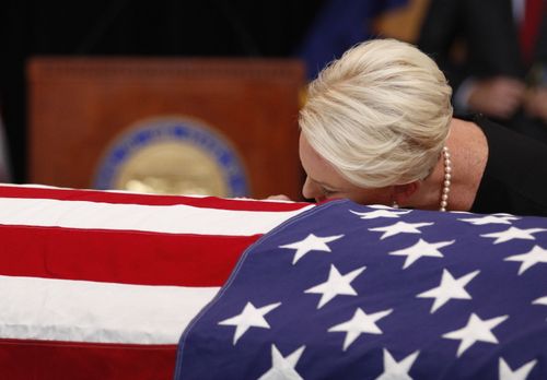 Cindy lays her head on the casket of her All-American hero John McCain.