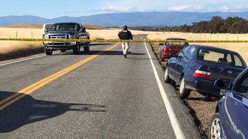 Crime tape blocks off Rancho Tehama Road leading into the Rancho Tehama subdivision in northern California. (AAP) 