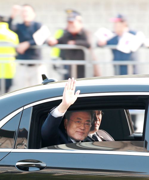 The motocade carrying South Korean President Moon Jae-in drives the through street on the way to the Military Demarcation Line (EPA)