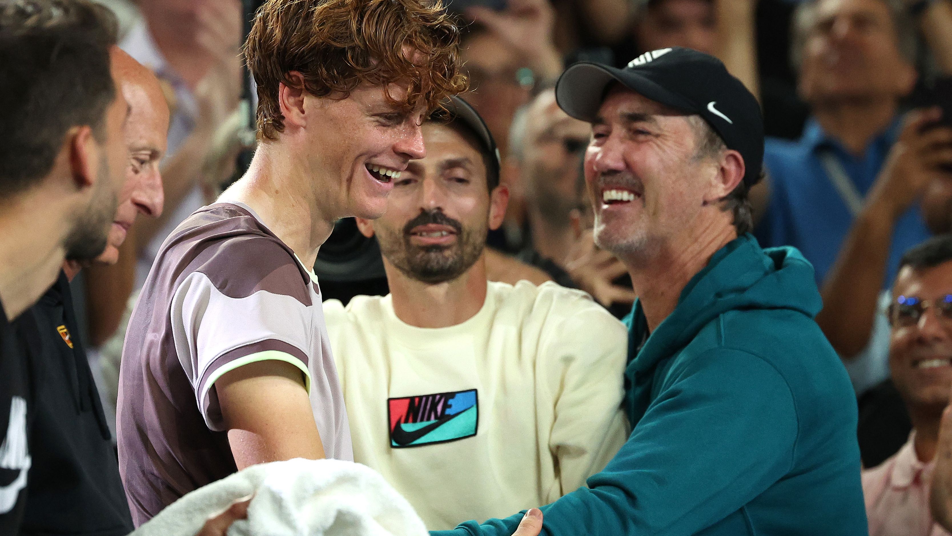 Jannik Sinner of Italy celebrates winning with coach Darren Cahill and his team.