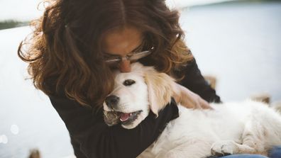 Woman hugging dog