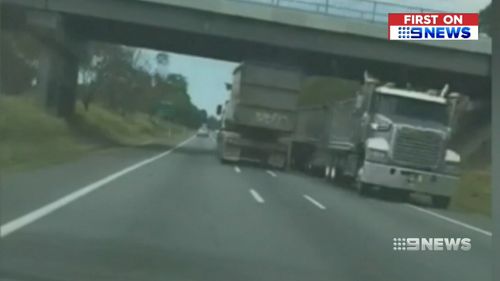 A Queensland driver has filmed the moment a rogue truck driver almost collided with dozens of oncoming cars on a busy highway.