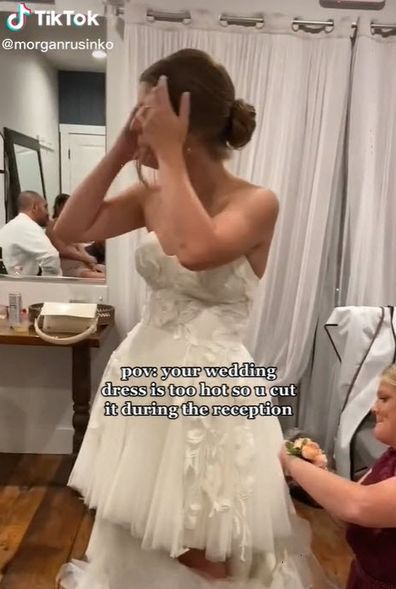 bride cuts wedding dress due to heat